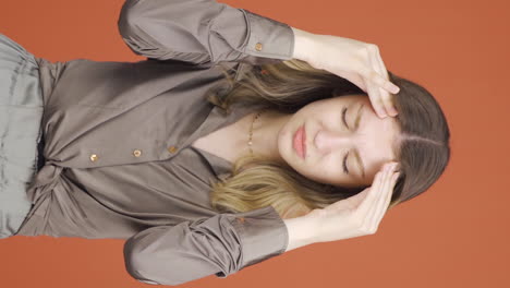 Vertical-video-of-Young-woman-with-headache.